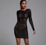 Front view of a woman wearing a black cutout bodycon dress on a grey background